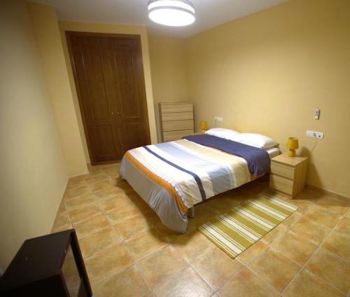 a bedroom with a large bed in a room at Modern Flat in Guejar Sierra in Güéjar-Sierra