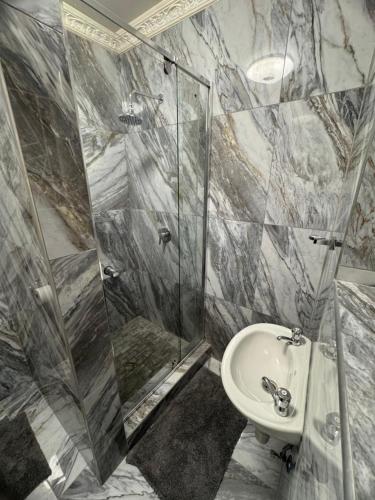 a bathroom with a shower and a sink at Inkinibe Self Catering in Windhoek