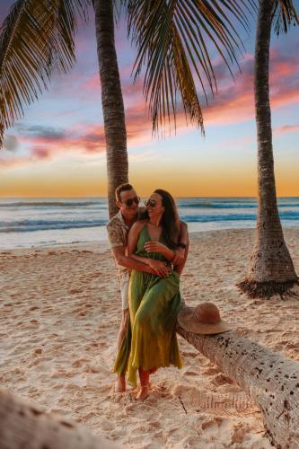 a man and a woman standing on a beach at Petit Lafitte Beach Front Hotel & Bungalows in Playa del Carmen