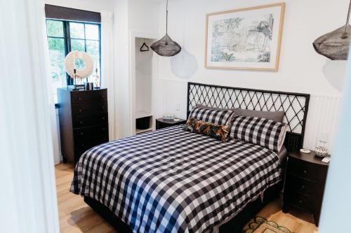 a bedroom with a black and white checkered bed at Ebony & Ivory Villa in Nelson Bay
