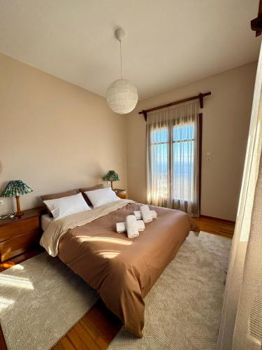 a bedroom with a large bed with towels on it at Patrikon in Zagora