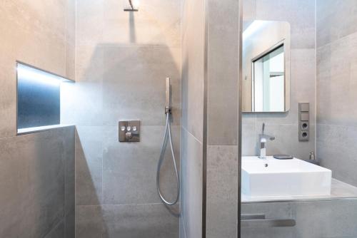 a bathroom with a shower and a white sink at Auszeit in Bad Zwischenahn