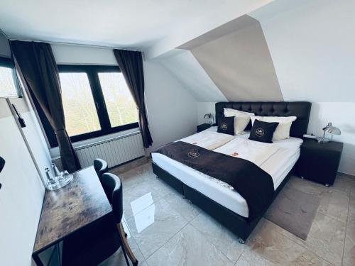 a bedroom with a large bed in a room at Hotel Royal in Leopoldshöhe