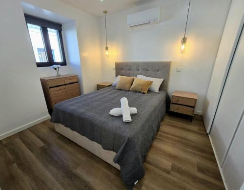 a bedroom with a bed with a white cross on it at Atlantic Dreams II in Pico da Pedra