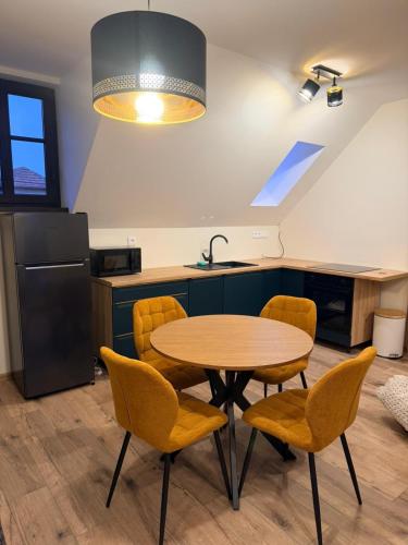 a kitchen with a table and chairs and a sink at Apartman Mia 5 in Liptovský Mikuláš