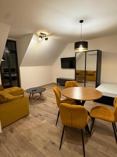 a living room with a table and chairs and a bed at Apartman Mia 5 in Liptovský Mikuláš