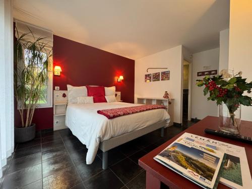 a bedroom with a large bed and a table at Entre montagnes et lac in Armoy