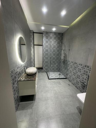 a bathroom with a tub and a sink and a mirror at Villa Mardakan in Mərdəkan