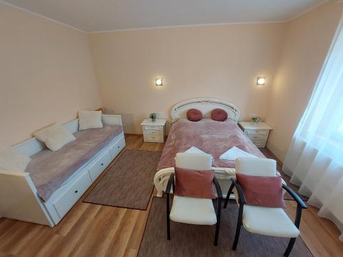 a bedroom with a bed and a table and chairs at E-Tekergők Háza in Bükkzsérc