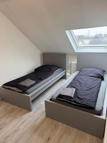 a bedroom with two beds and a window at Monteurwohnung Krefeld WorkStay in Krefeld