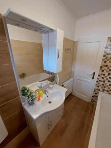 a bathroom with a sink and a mirror at E-Tekergők Háza in Bükkzsérc