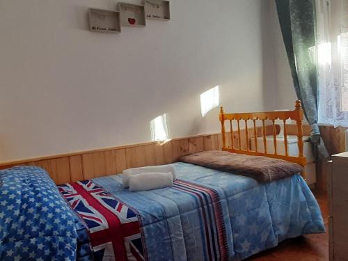 a bedroom with a bed with a blanket on it at Mallona in Pedro Rodríguez