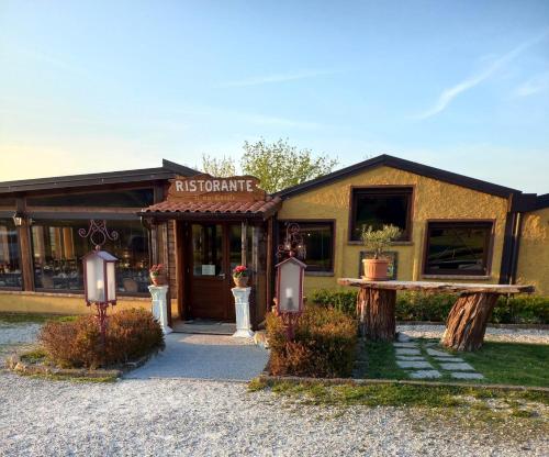 a building with a bench in front of it at Agriturismo Il Mio Casale in Monte Colombo