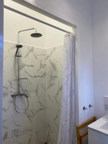 a bathroom with a shower with a shower curtain at Résidence Fleur de Café - Petite Terre in Deshaies