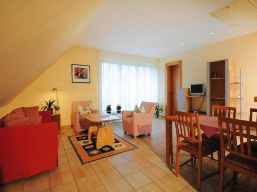 a living room with a table and chairs at Appartements Post Hiddensee in Vitte in Vitte