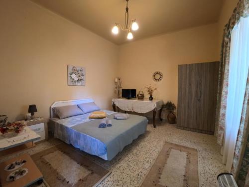 a bedroom with a bed and a table in it at Traditional Villa Stella in Archangelos