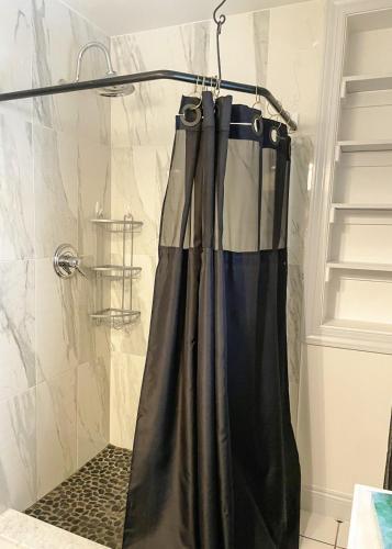 a shower curtain hanging in a bathroom at Family-Friendly Strasburg Escape | 50 Mile Views in Strasburg