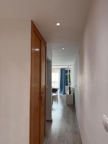 ein Flur mit einer Tür, die in ein Wohnzimmer führt in der Unterkunft Las Damas Piso18 in Benidorm