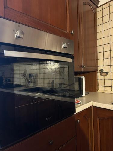 a kitchen with a black stove top oven at Al civico 7 Relax a due passi dal lago di Como in Oliveto Lario