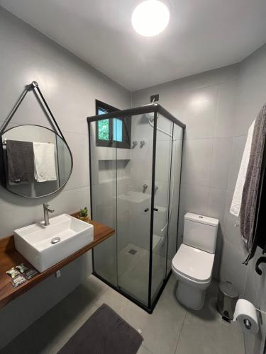 a bathroom with a shower and a toilet and a sink at Pousada Villa Julião in Ilhabela