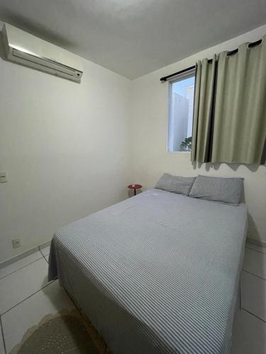 a bedroom with a bed and a window at Apartamento confortável para sua estadia in Teresina