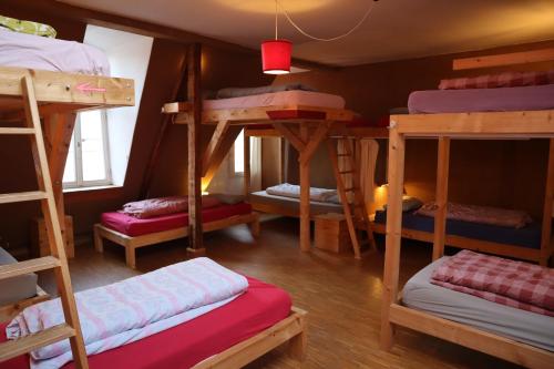 a room with four bunk beds in a house at schickSAAL* in Lübeck