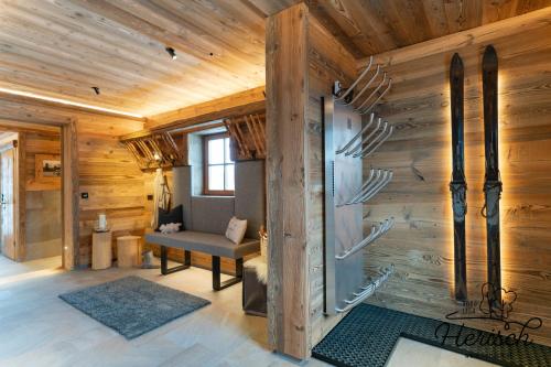 a living room with a wooden wall with antlers at Selbstversorgerhaus Herisch in Schladming