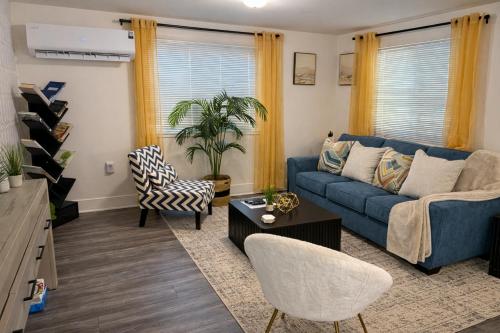 a living room with a blue couch and chairs at King Suite and Sofa Bed Fast WI-FI Easy DC Access in District Heights