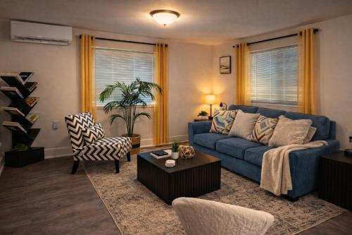 a living room with a blue couch and chairs at Private King Suite Near DC & Joint Base Andrews in District Heights