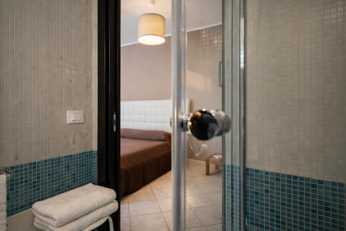 a person taking a picture of a bathroom with a shower at MyBed B&B in Cavallino di Lecce