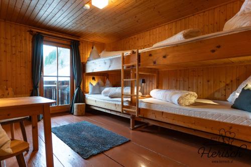 a bedroom with two bunk beds in a cabin at Selbstversorgerhaus Herisch in Schladming