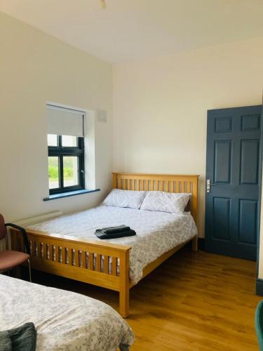 a bedroom with a bed and a blue door at 2 Bedroom Workers Apartment in Barrysbrook