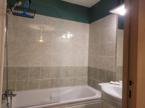 a bathroom with a bath tub and a toilet at welcome toEspace Zen in Levernois