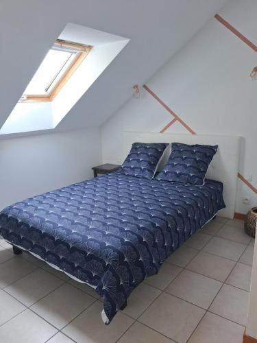 a bed in a white room with a window at welcome toEspace Zen in Levernois