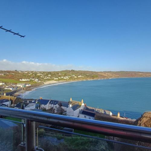 a view of a beach and the ocean at Harbour Views, Coverack in Helston