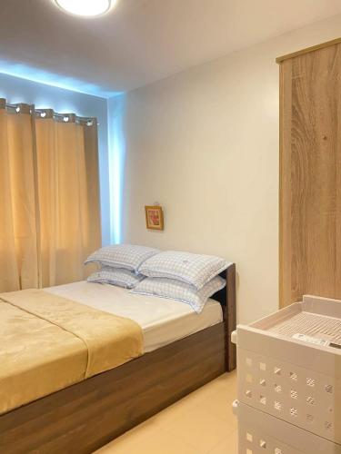 a bedroom with a bed with blue lights on it at ONE SPATIAL 2Bedrooms Apartment Flat LLD Iloilo City Philippines in Iloilo City