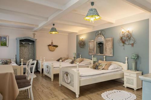 a group of four beds in a room at Zielone Zacisze in Murzynowo Kościelne