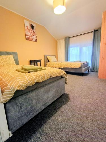 a bedroom with two beds and a couch at Casa Pop in Oradea
