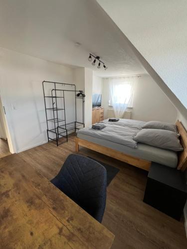 a bedroom with a large bed and a window at Ellis Häusle in Nagold