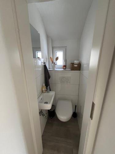 a small bathroom with a toilet and a sink at Ellis Häusle in Nagold