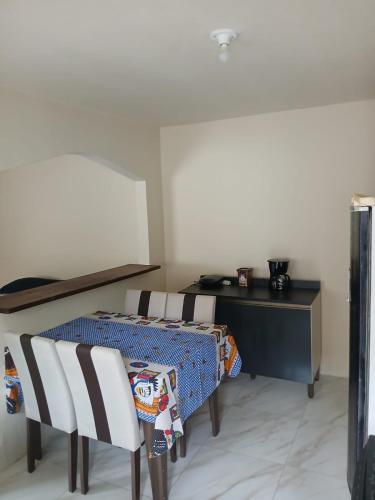 a room with a table and chairs and a desk at Casas oliveira in Paraty