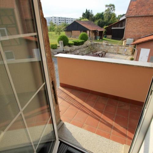 an open sliding glass door of a balcony with a patio at Fewo-Baunatal / Ferienwohnung "Am Pilgerbach" in Baunatal