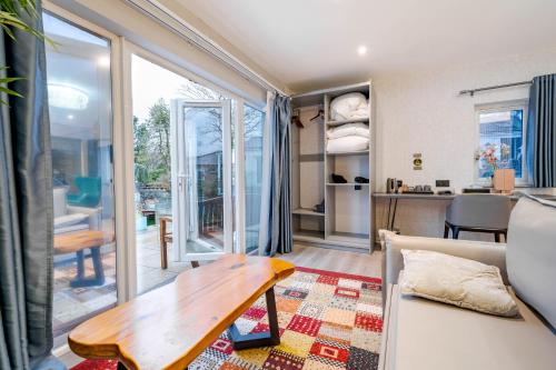 a living room with a couch and a table at Waterhead Bath Suites in Ambleside