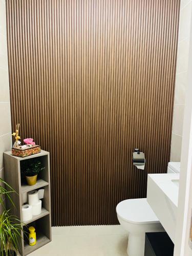 a bathroom with a toilet and a brown wall at Haven Stays - D15A5DF in Tyrrelstown