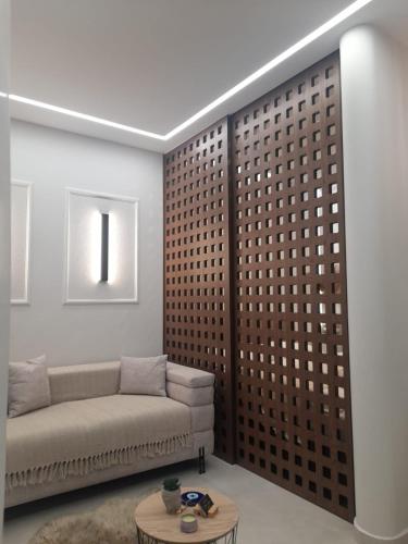 a living room with a couch and a table at Elite Suite in Xanthi