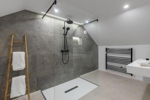a bathroom with a shower and a sink at La Perle Bleue in Algrange