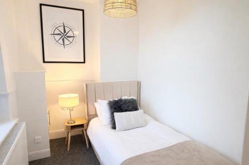 a bedroom with a bed with a pillow on it at 4 bedrooms 8 beds Wi-FI smart tv games room in Hull