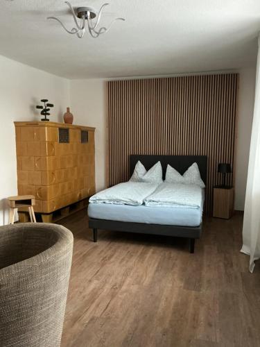 a bedroom with a bed with white sheets and pillows at Ferienwohnung am Netzener See in Lehnin