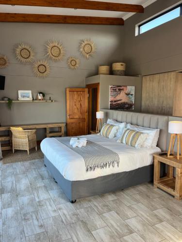 a bedroom with a large bed in a room at Oppi See Beach House in Wilderness