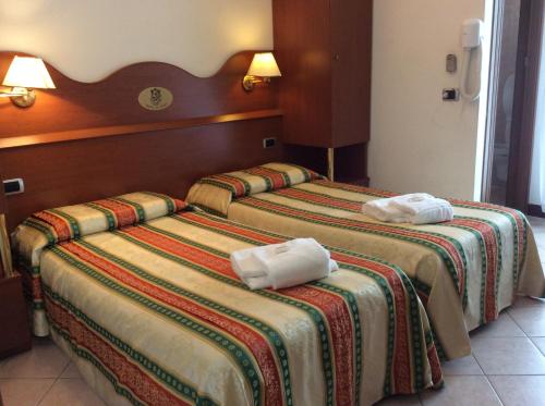 Postel nebo postele na pokoji v ubytování Hotel Pizzeria Ristorante "Al Leone"